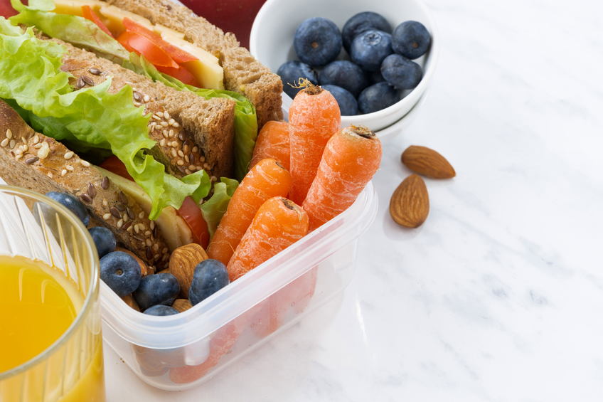 lunch box with sandwich of wholemeal bread on white background, closeup